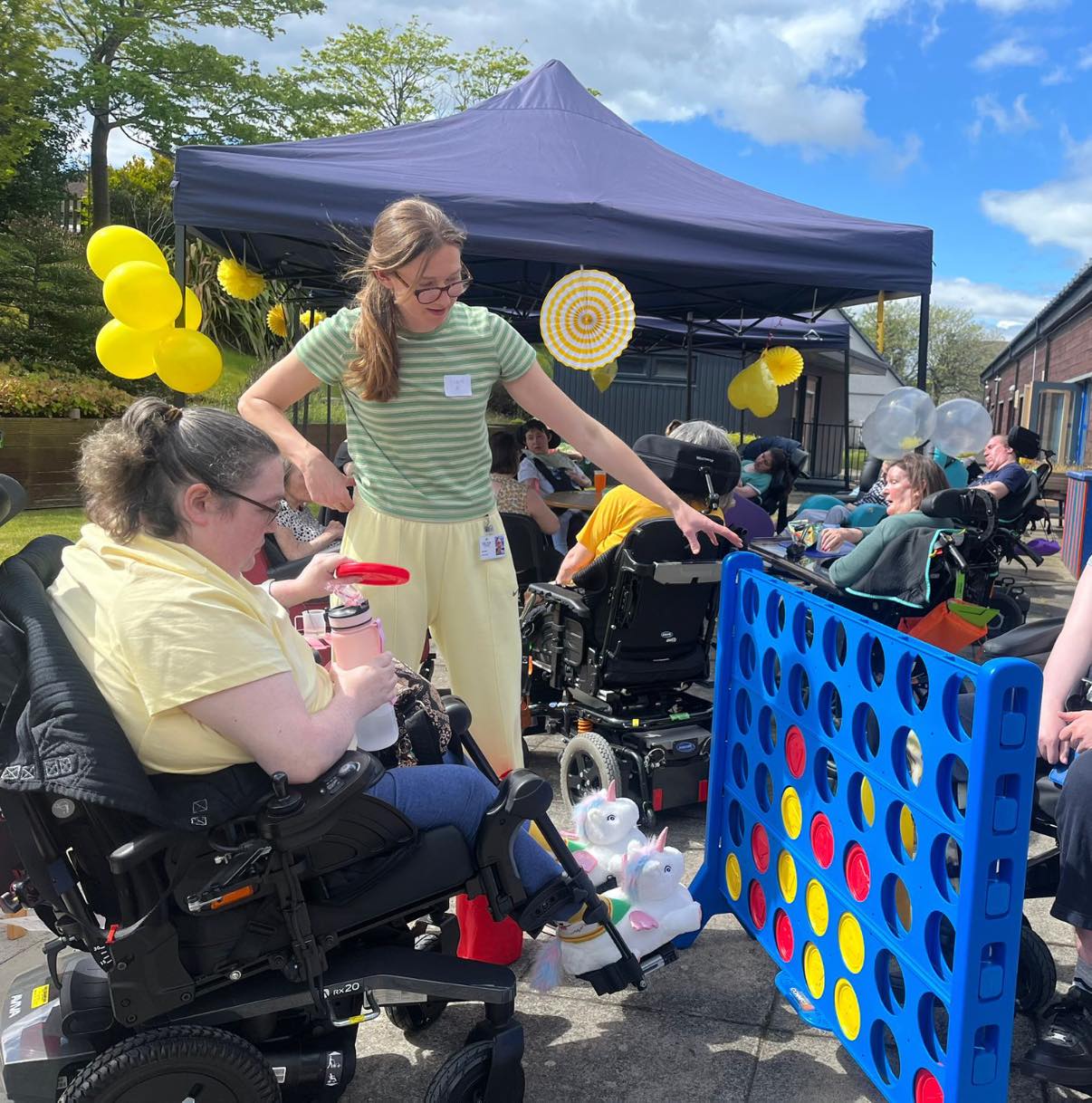 resident and another adult playing connect 4