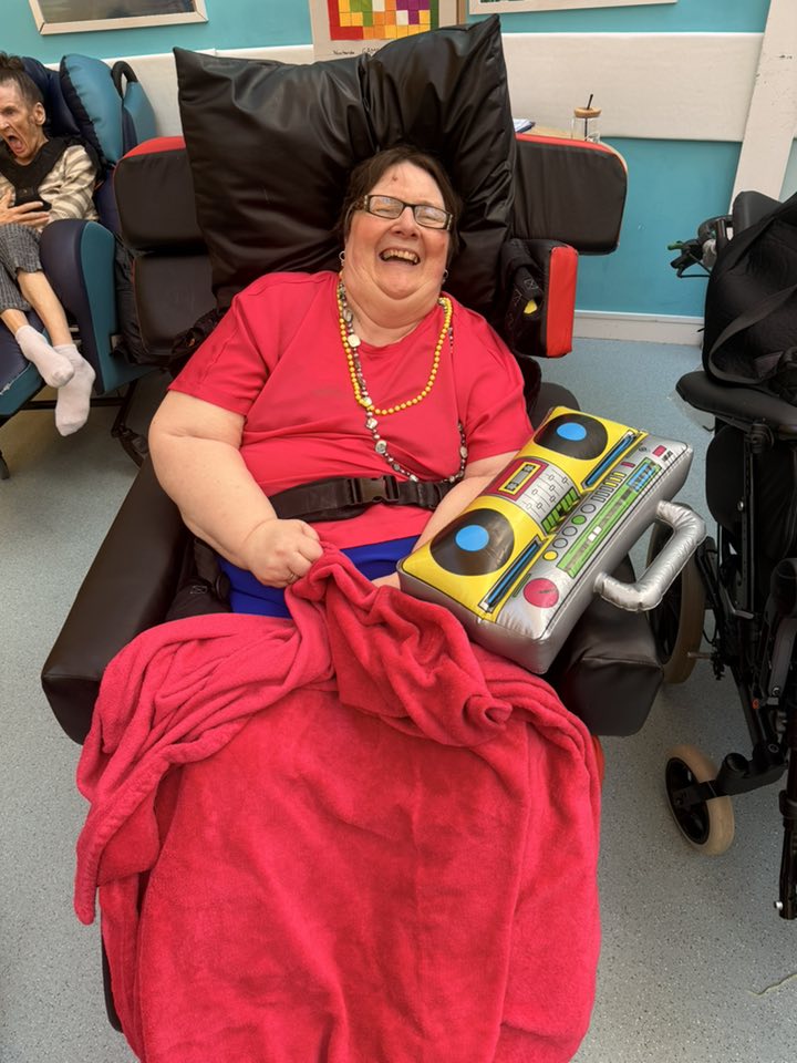 older lady sat down with an inflatable speaker