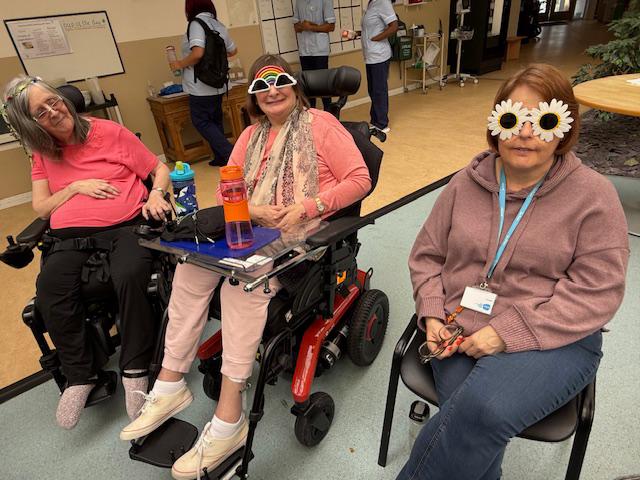care home residents wearing novelty glasses